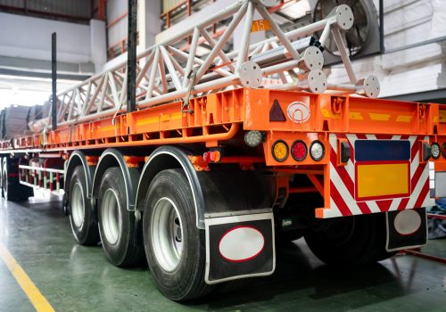 side view on truck with big wheel and loading steel pole on truck.